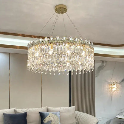 Luxurious gold-toned decorbites crystal chandelier with cascading clear crystal prisms for luxe living room decor
