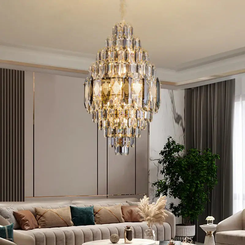 A decorbites crystal chandelier with gold-toned accents and cascading clear glass prisms for luxe villa lighting