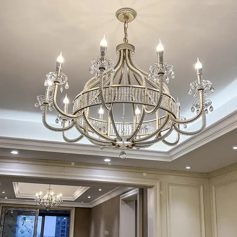Elegant silver-toned pendant light with crystal accents and lit candle-style bulbs decorbites crystal chandelier for luxe rooms