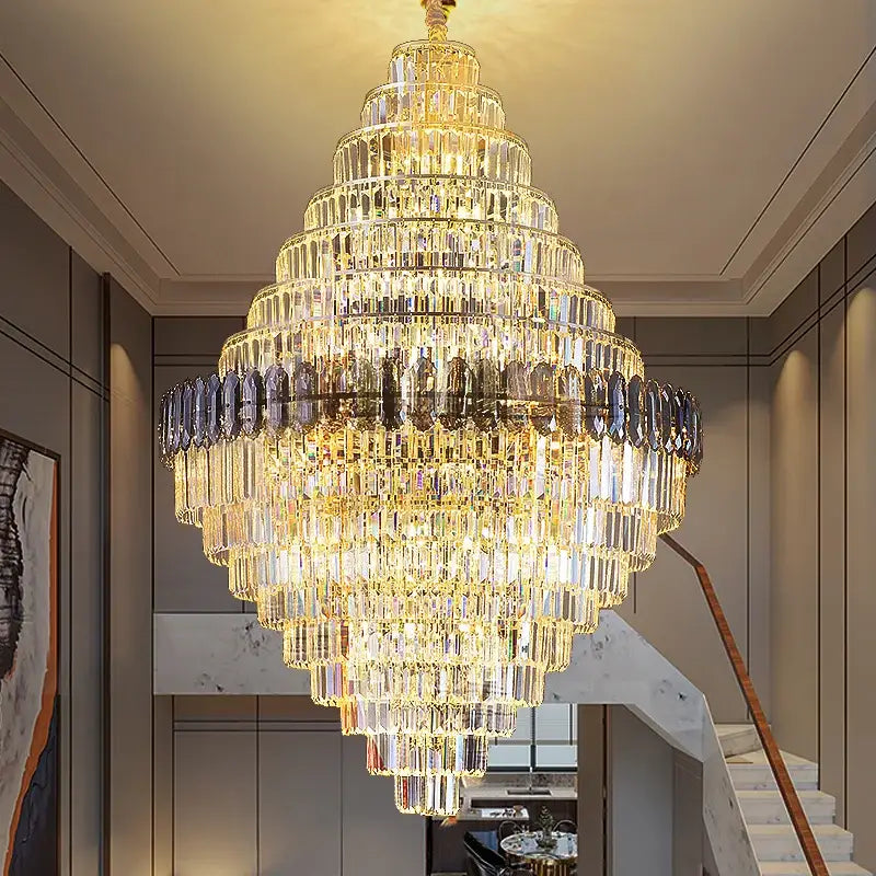 Decorbites crystal chandelier with cascading clear and smoky glass prisms in gold for luxe penthouse stairwell lighting