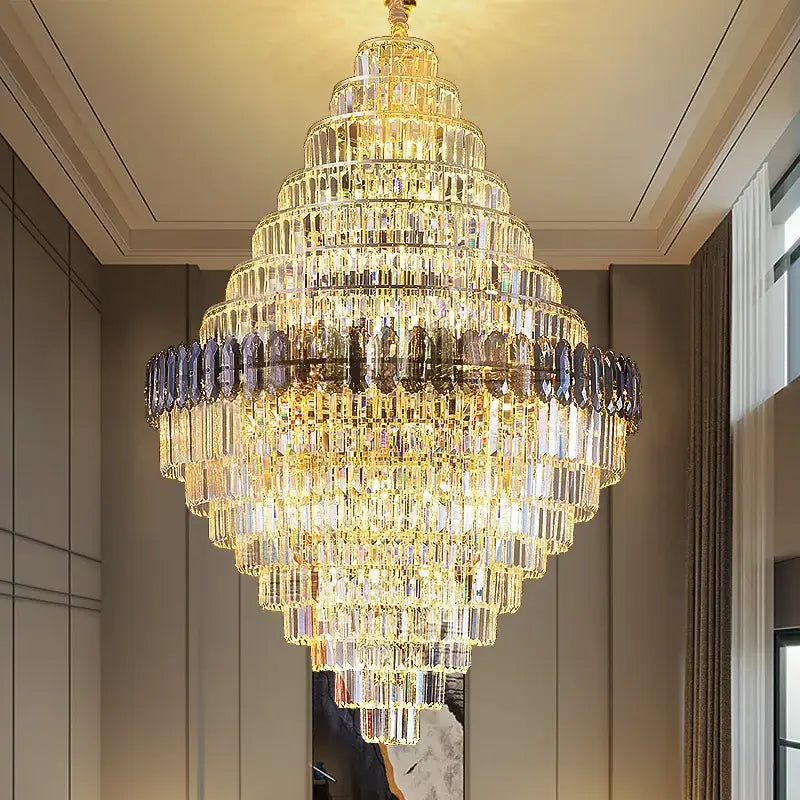 DecorBites crystal chandelier with cascading clear and dark blue crystals on gold frame for luxe stairwell lighting