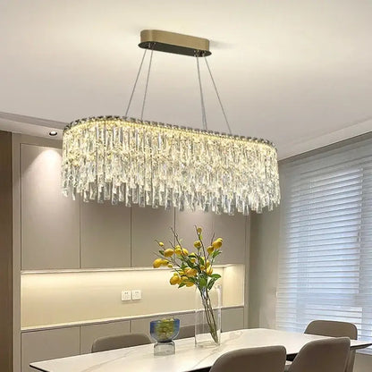 A modern decorbites crystal chandelier with cascading clear crystal prisms and a sleek gold-toned ceiling mount