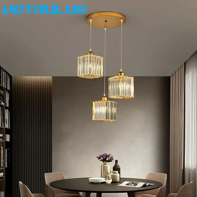 Gold-toned decorbites crystal chandelier pendant light with clear vertical crystal panels and circular ceiling mount for indoor use