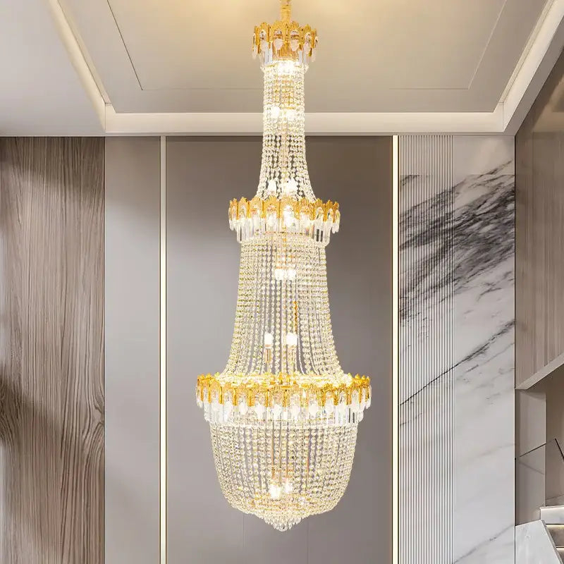 Decorbites crystal chandelier multi-tiered with gold-toned accents and glass beads for luxury duplex stairwell design