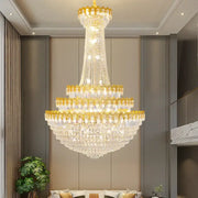 A multi-tiered decorbites crystal chandelier with gold-toned accents and clear crystals for luxury living rooms