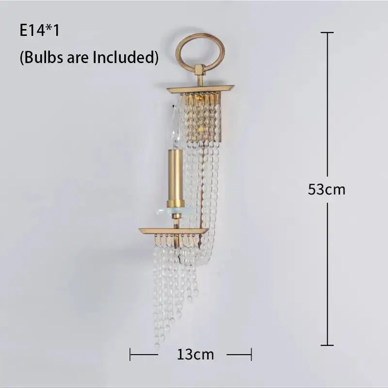 Gold-toned wall sconce with cascading clear crystal beads and candle-style bulb holder in decorbites crystal chandelier