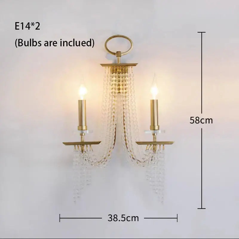 Gold-toned DecorBites crystal chandelier wall sconce with two candle-style bulbs and cascading crystal beads for indoor decor