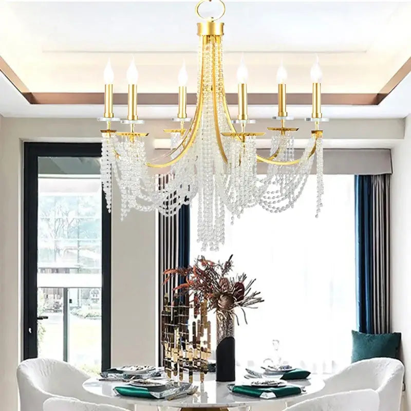 Gold-toned decorbites crystal chandelier with cascading crystal beads and candle-style bulbs for romantic indoor decor