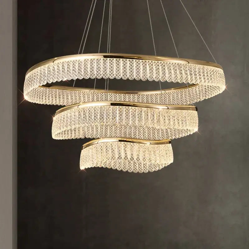 Gold-toned DecorBites crystal chandelier with spiral design and cascading crystal tiers for luxury LED lighting