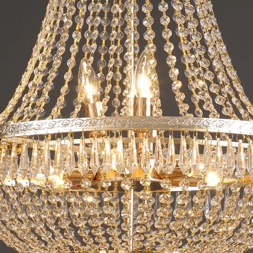 Golden decorbites crystal chandelier with cascading clear beads and teardrop crystals on ornate silver frame for luxury lighting