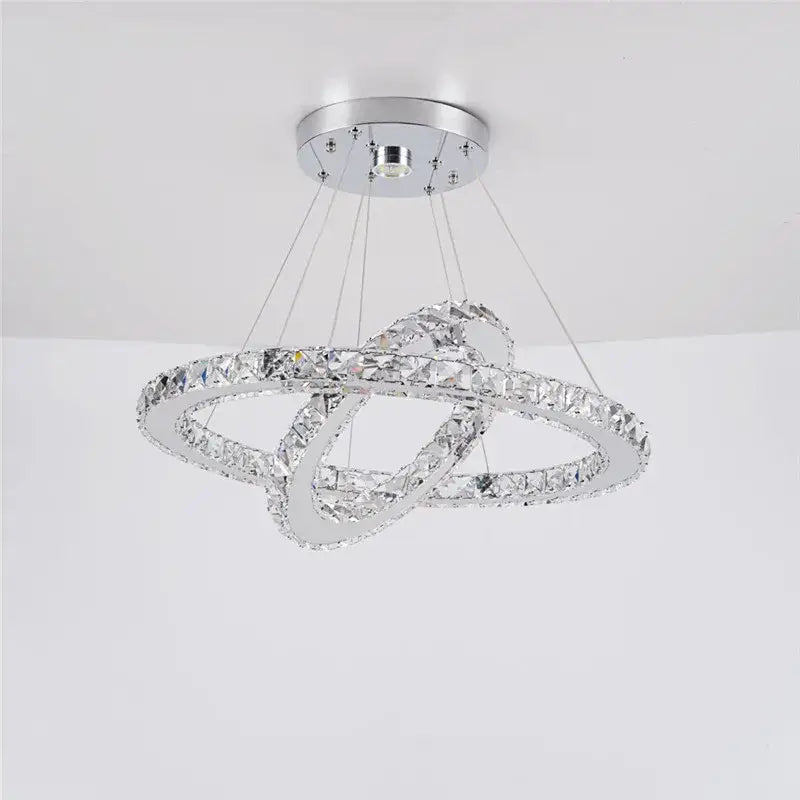 A modern chrome-finished decorbites crystal chandelier featuring two interlocking crystal rings for living and dining rooms