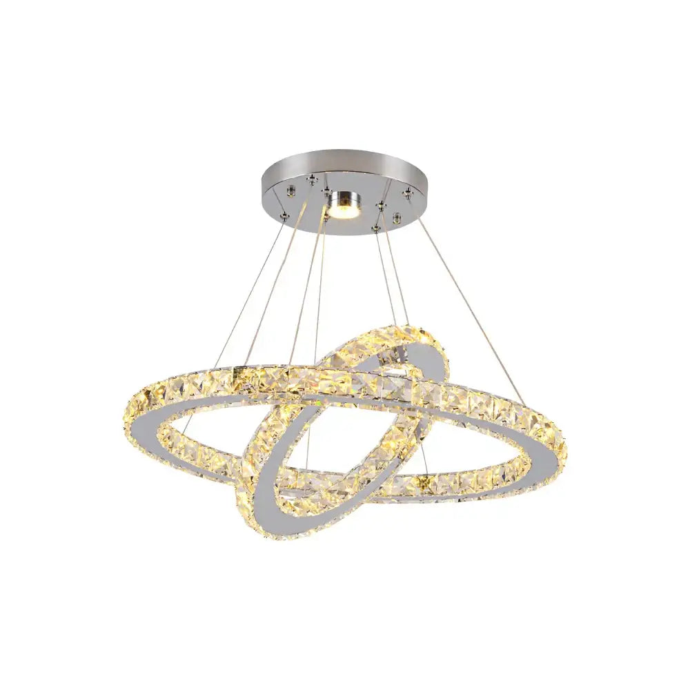 Modern chrome-finished decorbites crystal chandelier with interlocking crystal rings emitting warm golden light for living room