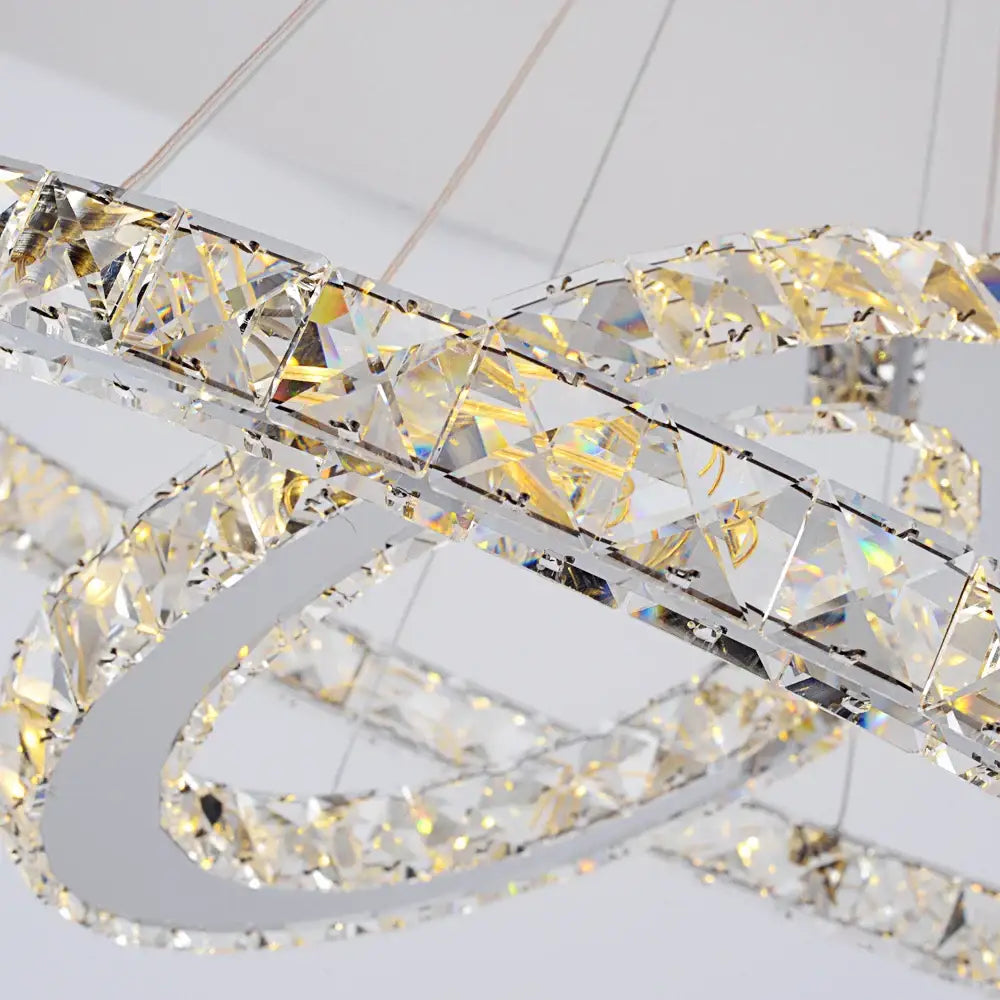 A modern multi-tiered decorbites crystal chandelier with faceted clear crystals for living and dining room lighting
