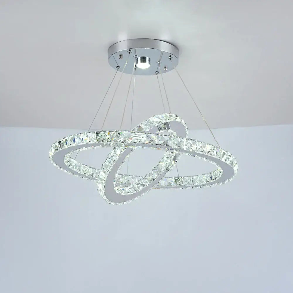 A modern chrome decorbites crystal chandelier with two interlocking crystal rings for luxury living room lighting