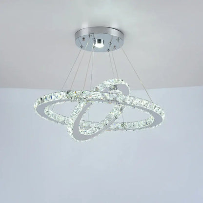 A modern chrome decorbites crystal chandelier with two interlocking crystal rings for luxury living room lighting