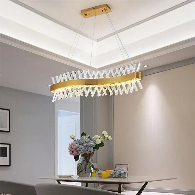 Gold-toned decorbites crystal chandelier with modern geometric design and clear crystal elements for luxury lighting