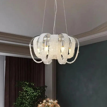 A modern multi-tiered decorbites crystal chandelier with sleek chrome frame and clear crystal beads for luxury lighting