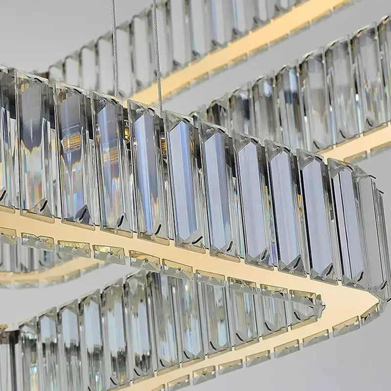 Modern double-tiered decorbites crystal chandelier with clear crystal prisms and gold-toned metal frame for luxury spaces