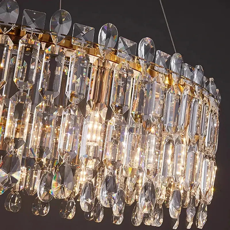 A luxurious gold-toned decorbites crystal chandelier with cascading clear crystal prisms for elegant living rooms and bedrooms