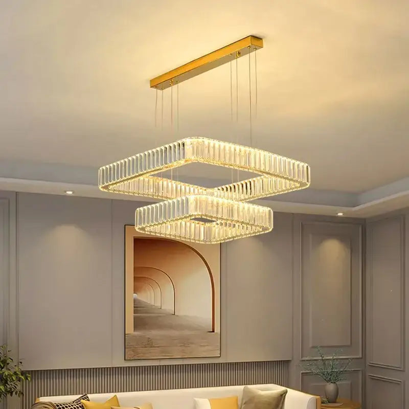 Modern double-tiered decorbites crystal chandelier with gold rectangular frame and cascading clear crystal rods for luxury living spaces