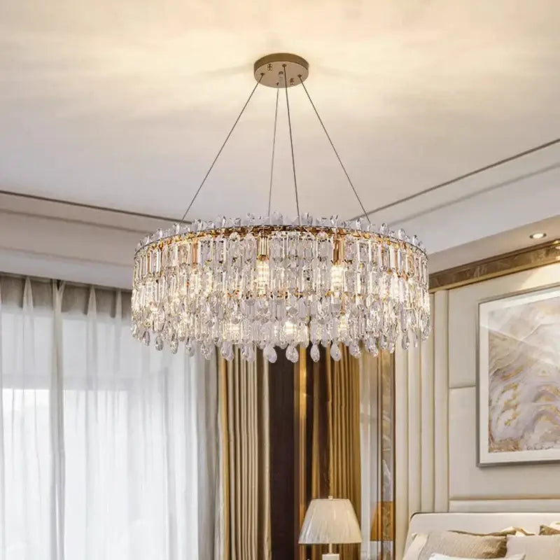 A decorbites crystal chandelier with a gold-toned frame and clear faceted crystals for luxury living spaces