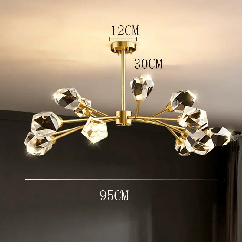 Gold-toned decorbites crystal chandelier with faceted crystal orbs and brass stem for luxury living room lighting