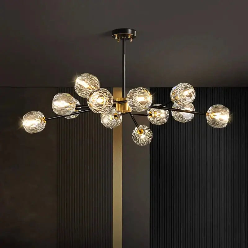 Modern decorbites crystal chandelier with black metal arms gold accents and faceted crystal globe shades for living room lighting