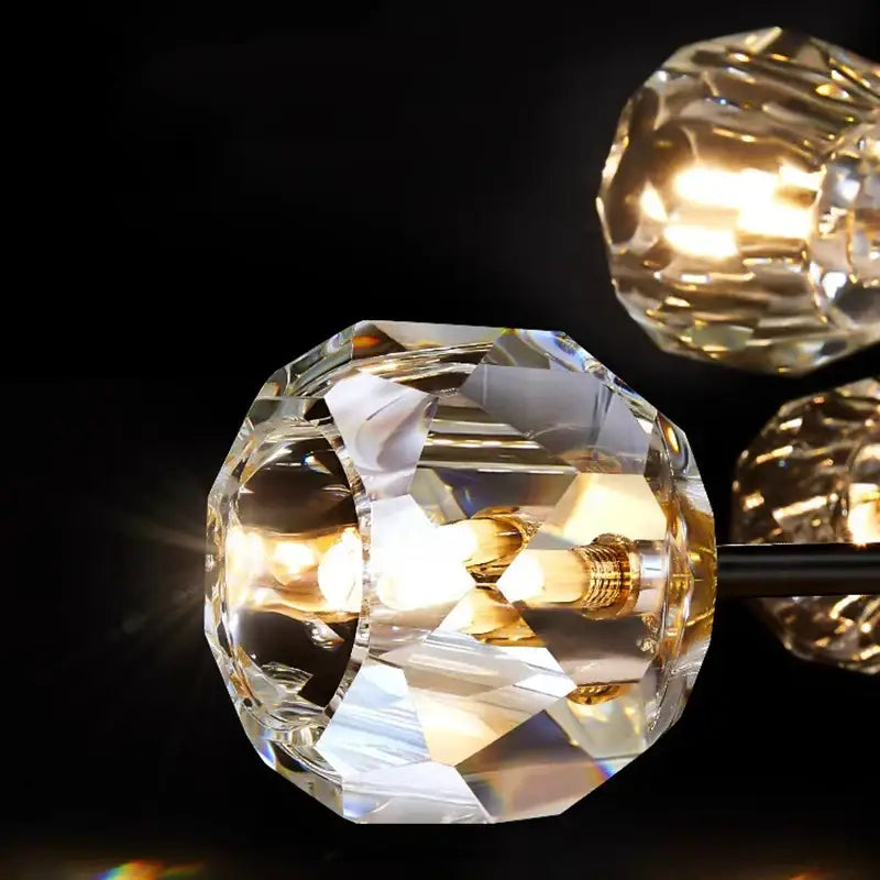 DecorBites crystal chandelier featuring clear faceted crystal globes with golden filament bulbs for luxury living areas