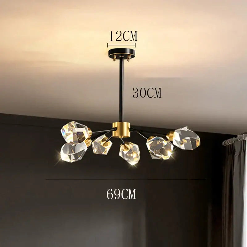 A modern decorbites crystal chandelier with a black stem gold accents and five faceted crystal pendants for luxury living room lighting
