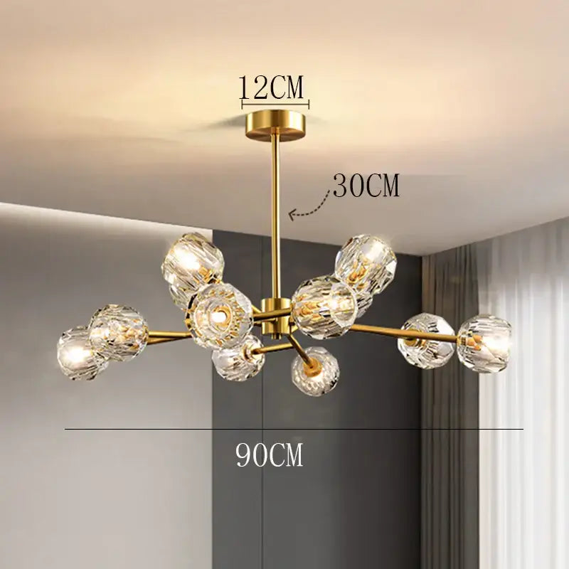 Gold-toned decorbites crystal chandelier with multiple clear faceted crystal globes for luxury living and dining rooms