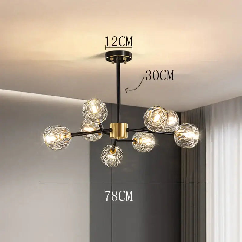 Modern decorbites crystal chandelier with black rod and gold accents featuring clear faceted glass globes for living room