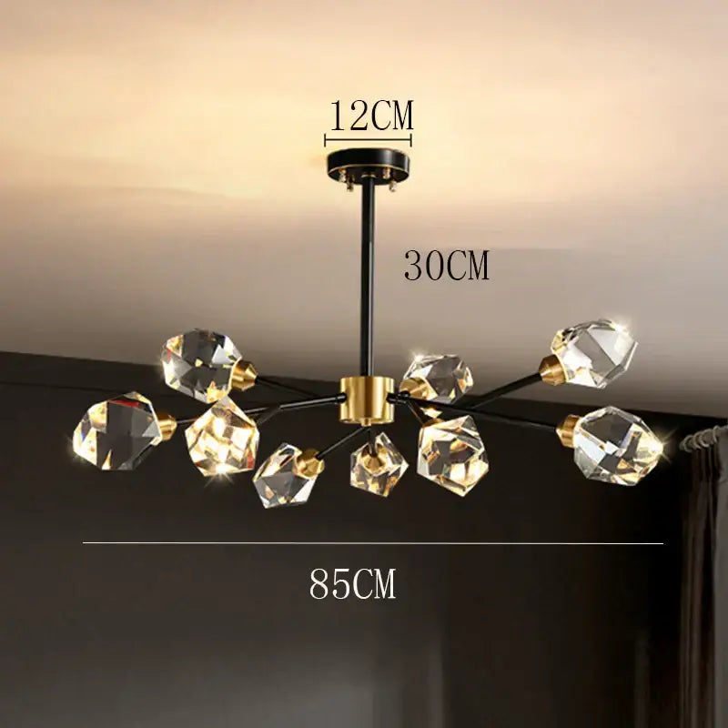 Modern decorbites crystal chandelier with black and gold metal arms holding faceted clear glass crystals for luxury living room lighting