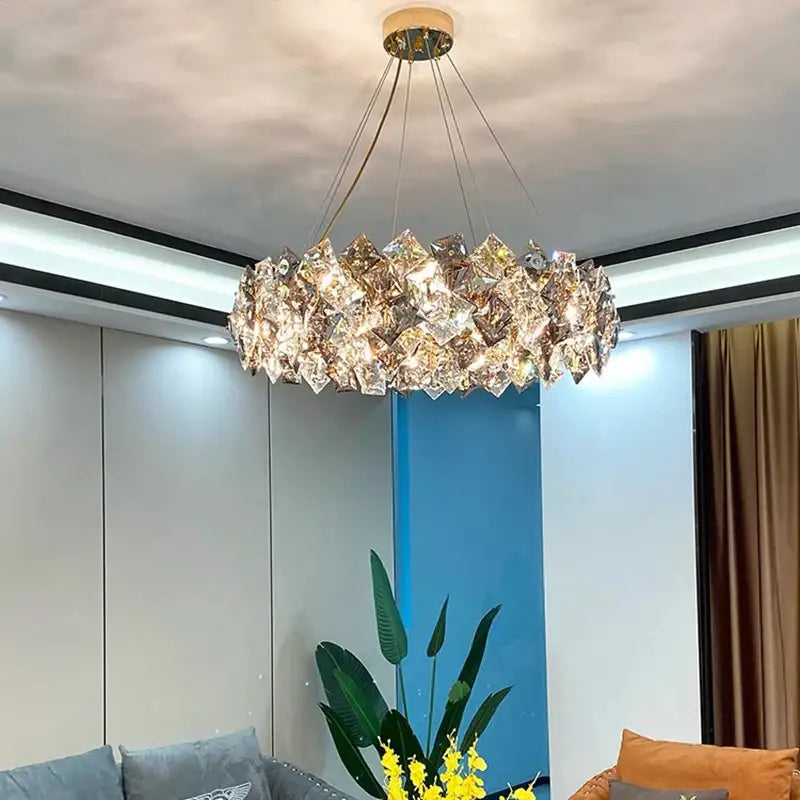 A modern decorbites crystal chandelier with a golden metal frame and faceted crystals for luxury living rooms