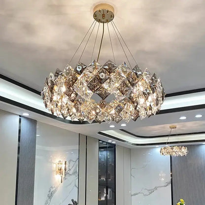 A modern decorbites crystal chandelier with faceted crystal layers and a central golden fixture for luxury living spaces