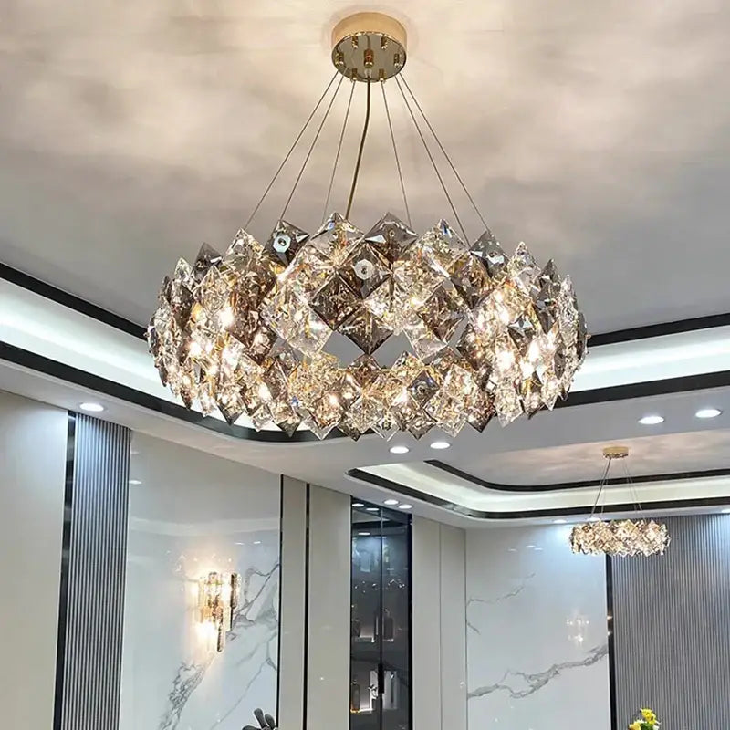 A modern decorbites crystal chandelier with faceted crystal layers and a central golden fixture for luxury living spaces