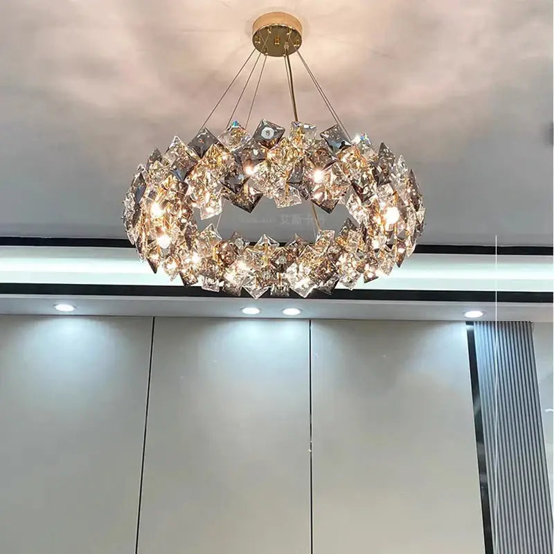 A modern decorbites crystal chandelier featuring faceted crystals arranged in a ring around a gold-toned fixture