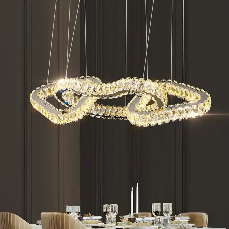 A decorbites crystal chandelier with double-looped design warm lights and sleek metallic frame for luxury spaces