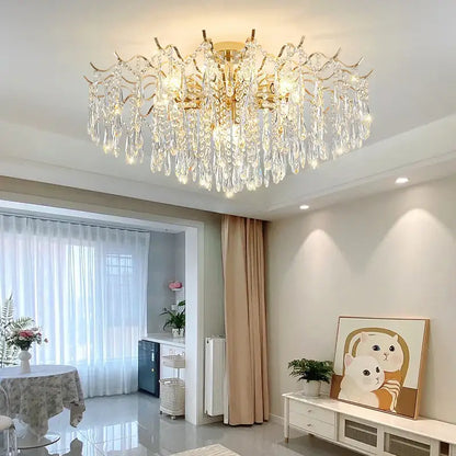 A luxurious gold-toned decorbites crystal chandelier with cascading crystal droplets for elegant living room lighting