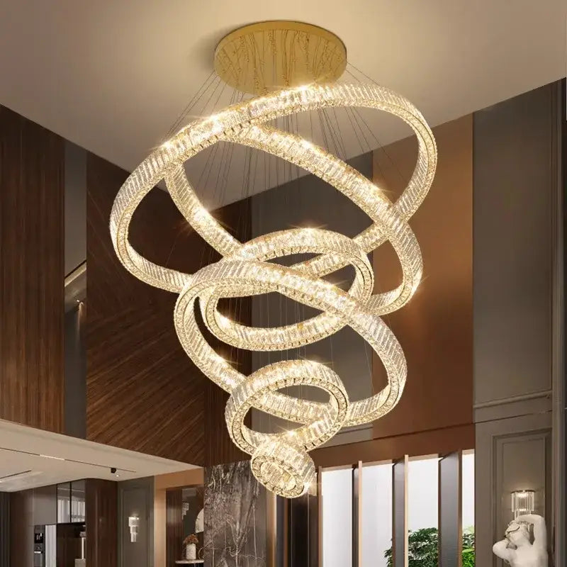 A decorbites crystal chandelier featuring modern multi-tiered interlocking crystal rings with a gold-toned mount