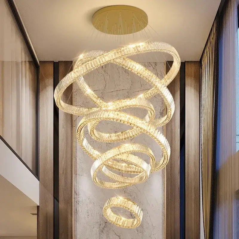 A modern decorbites crystal chandelier featuring gold-toned metal and clear crystal rings for luxury living rooms