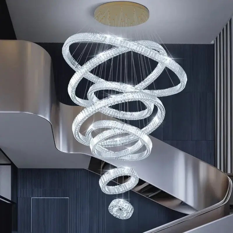 A modern decorbites crystal chandelier with multiple clear crystal rings for luxury living room and stair lighting