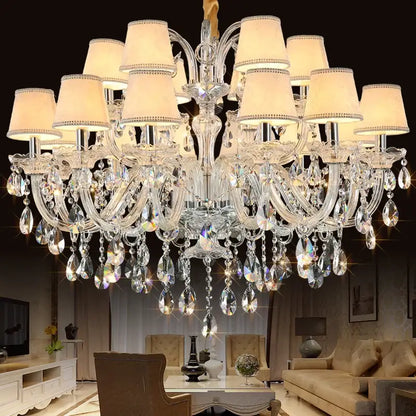 DecorBites crystal chandelier with multiple tiers of clear faceted glass droplets and cream lampshades for living room