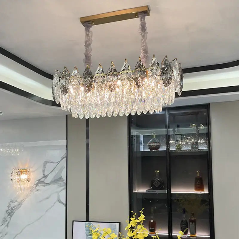 Decorbites crystal chandelier with gold-toned mount and cascading clear faceted crystals for modern luxury lighting