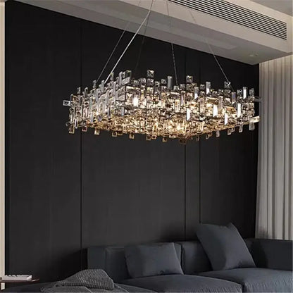 A modern rectangular decorbites crystal chandelier with clear and gold-toned crystals in a cascading design