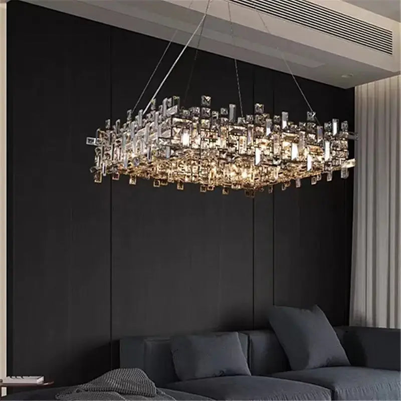 A modern rectangular decorbites crystal chandelier with clear and gold-toned crystals in a cascading design