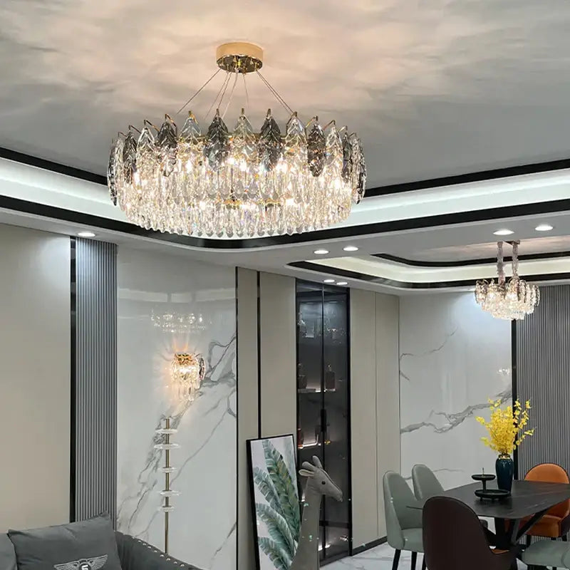 A decorbites crystal chandelier featuring a gold-toned center with cascading clear faceted crystals for modern luxury lighting