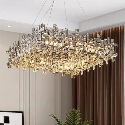 A modern rectangular decorbites crystal chandelier with clear and gold-toned prisms for living and dining rooms