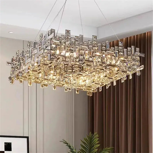 A modern rectangular decorbites crystal chandelier with clear and gold-toned prisms for living and dining rooms
