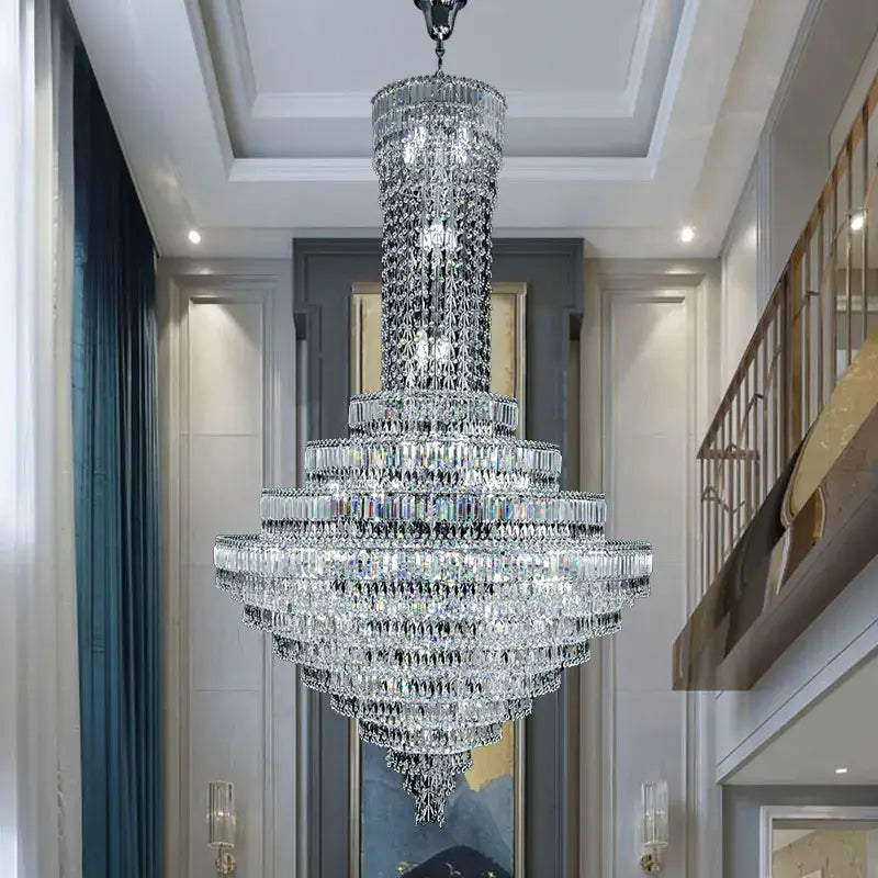 A multi-tiered decorbites crystal chandelier with clear faceted crystals for luxury modern staircase and living room lighting