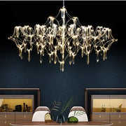 A modern decorbites crystal chandelier with metallic frame and teardrop glass pendants for luxury living spaces